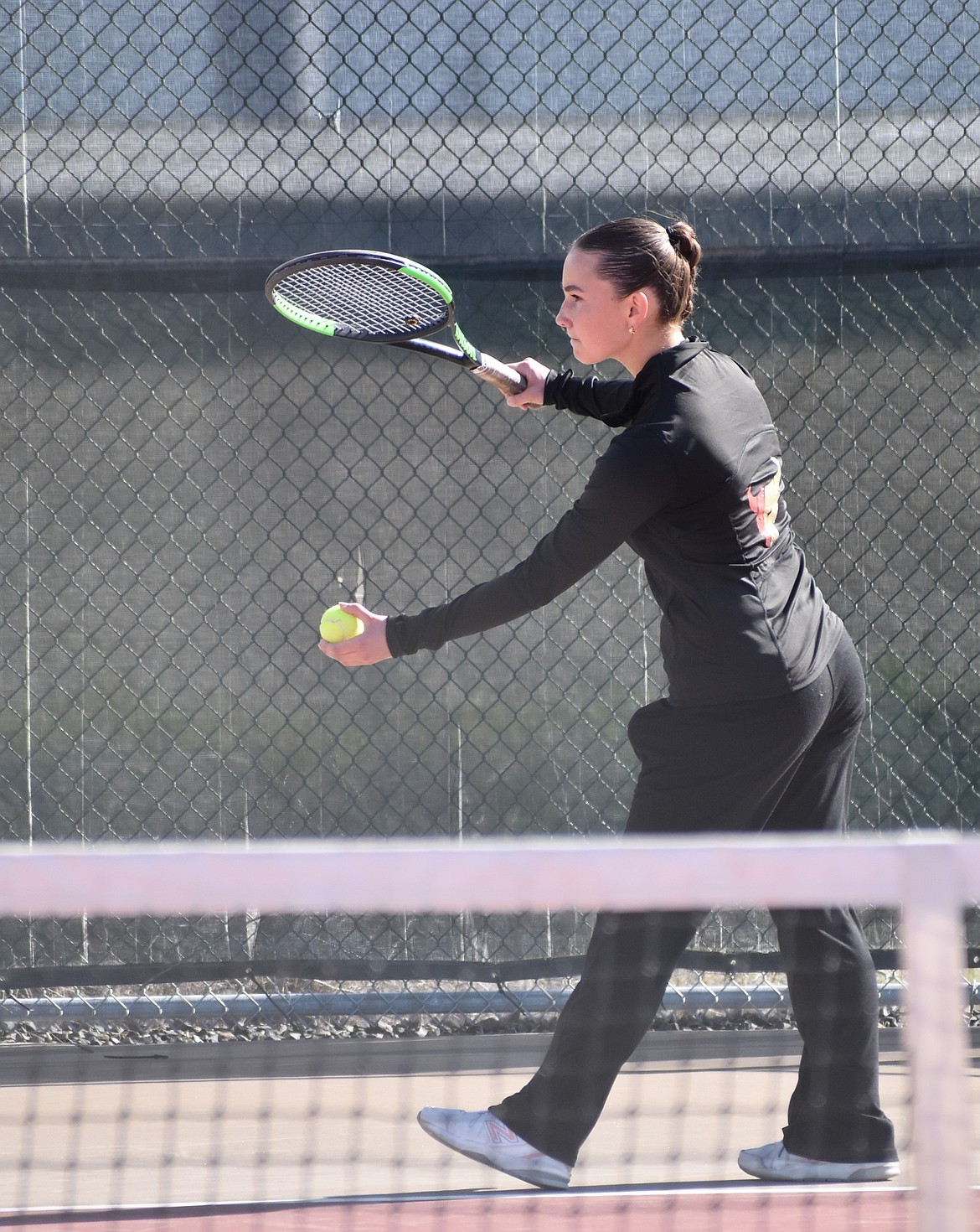 Moses Lake’s Ariah Louiseau prepares to serve to her Sunnyside opponent during Wednesday afternoon’s second singles matchup.