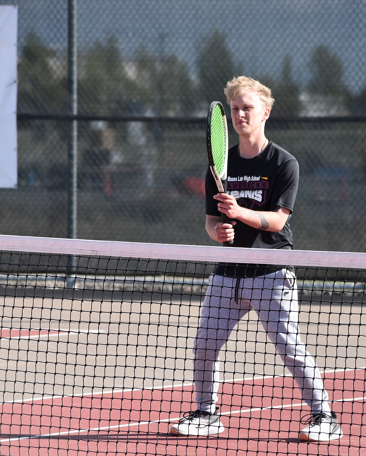 Moses Lake’s Emmett Sisney stands ready at the net as he waits for his partner, Jeremiah Acevedo, to serve during second doubles.