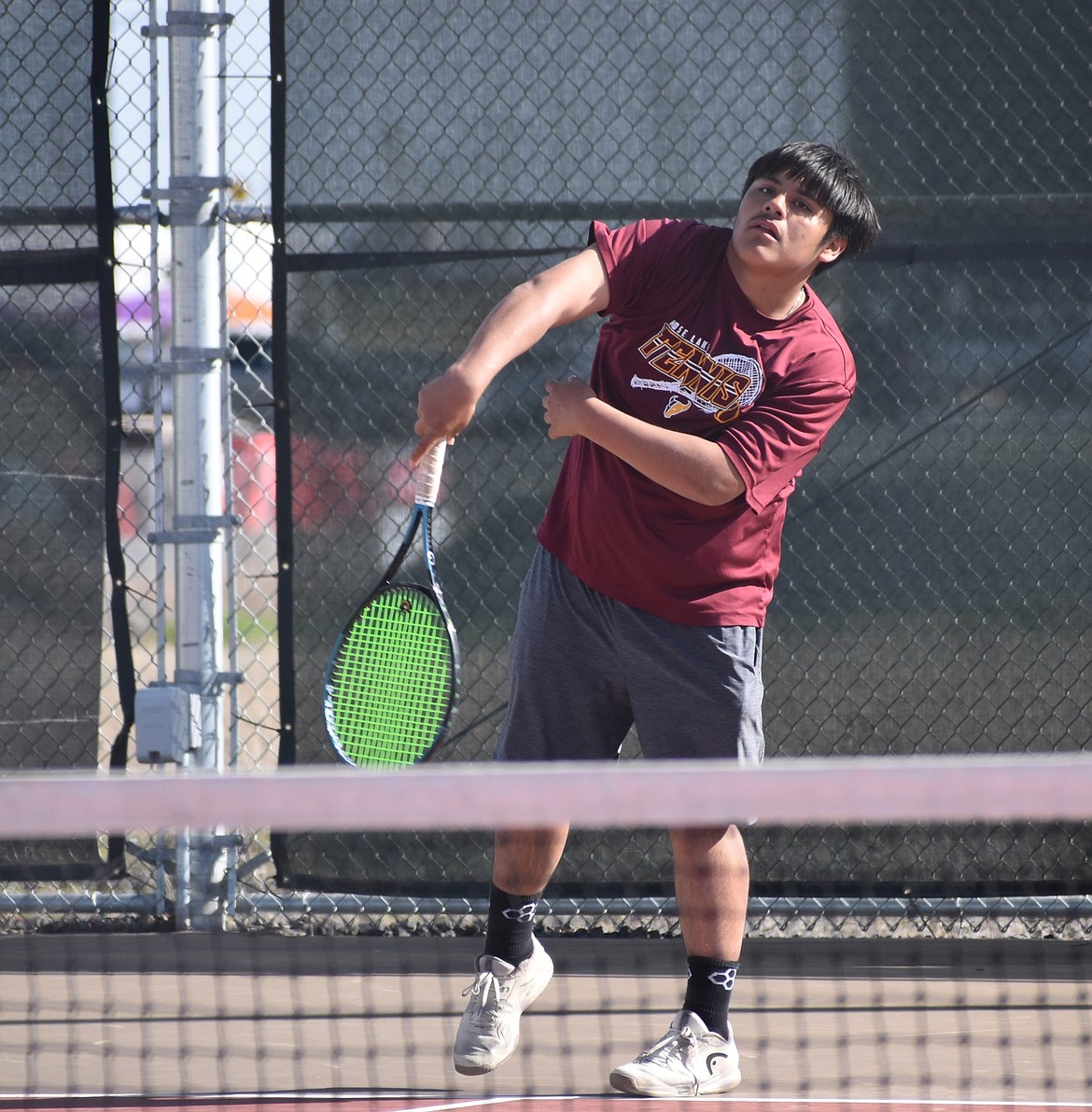 Mavs doubles player, Jeremiah Acevedo, hits a serve over to the opposing Sunnyside doubles team during the second doubles match Wednesday.