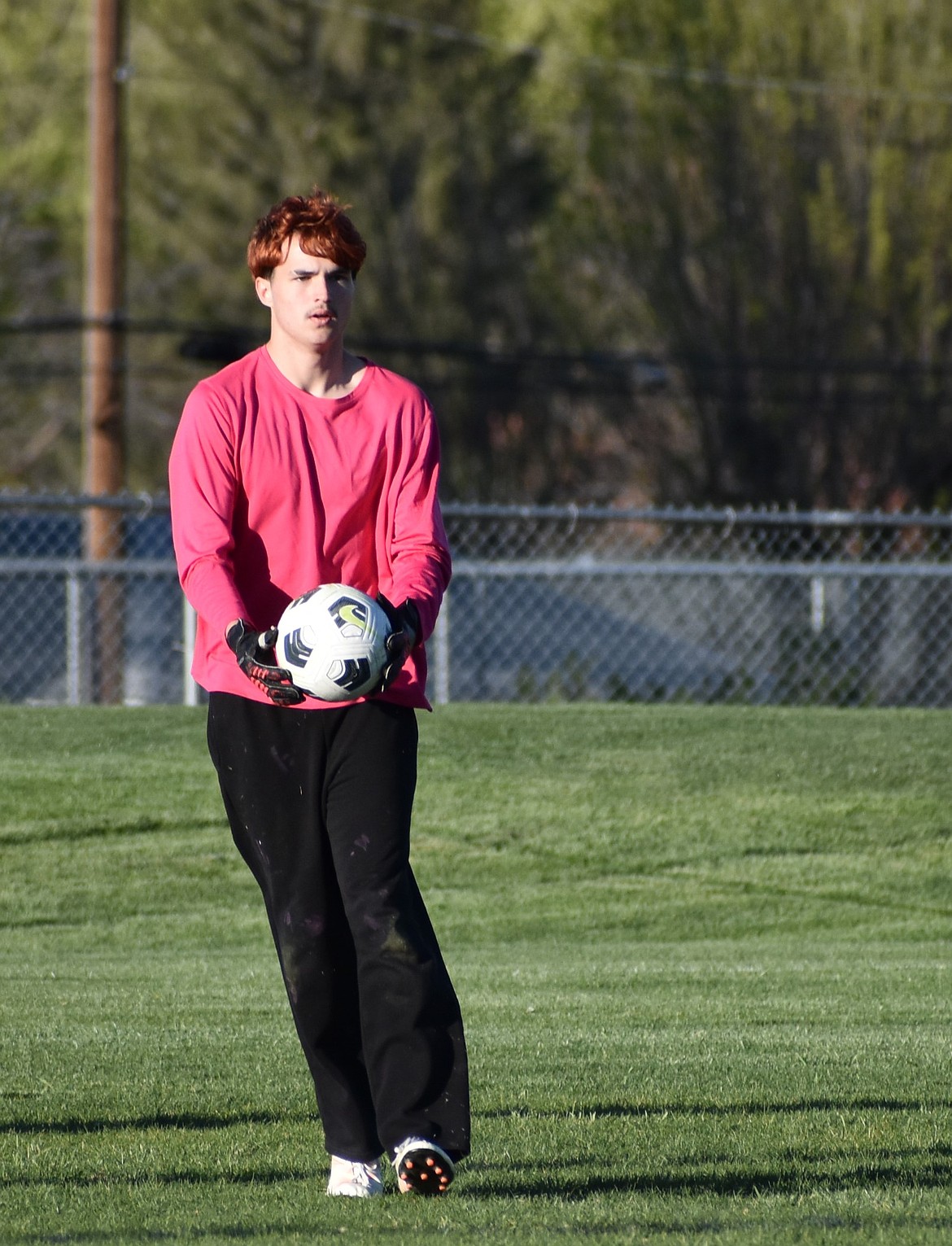 Chris Heaps from Soap Lake prepares to kick away the ball after making a successful stop against Okanogan.