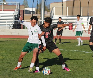 Dominik Plascencia (14) and Johndel Garcia (8) battle for control of the ball Thursday. The Othello Huskies defeated the Quincy Jacks 3-2 in overtime penalties.