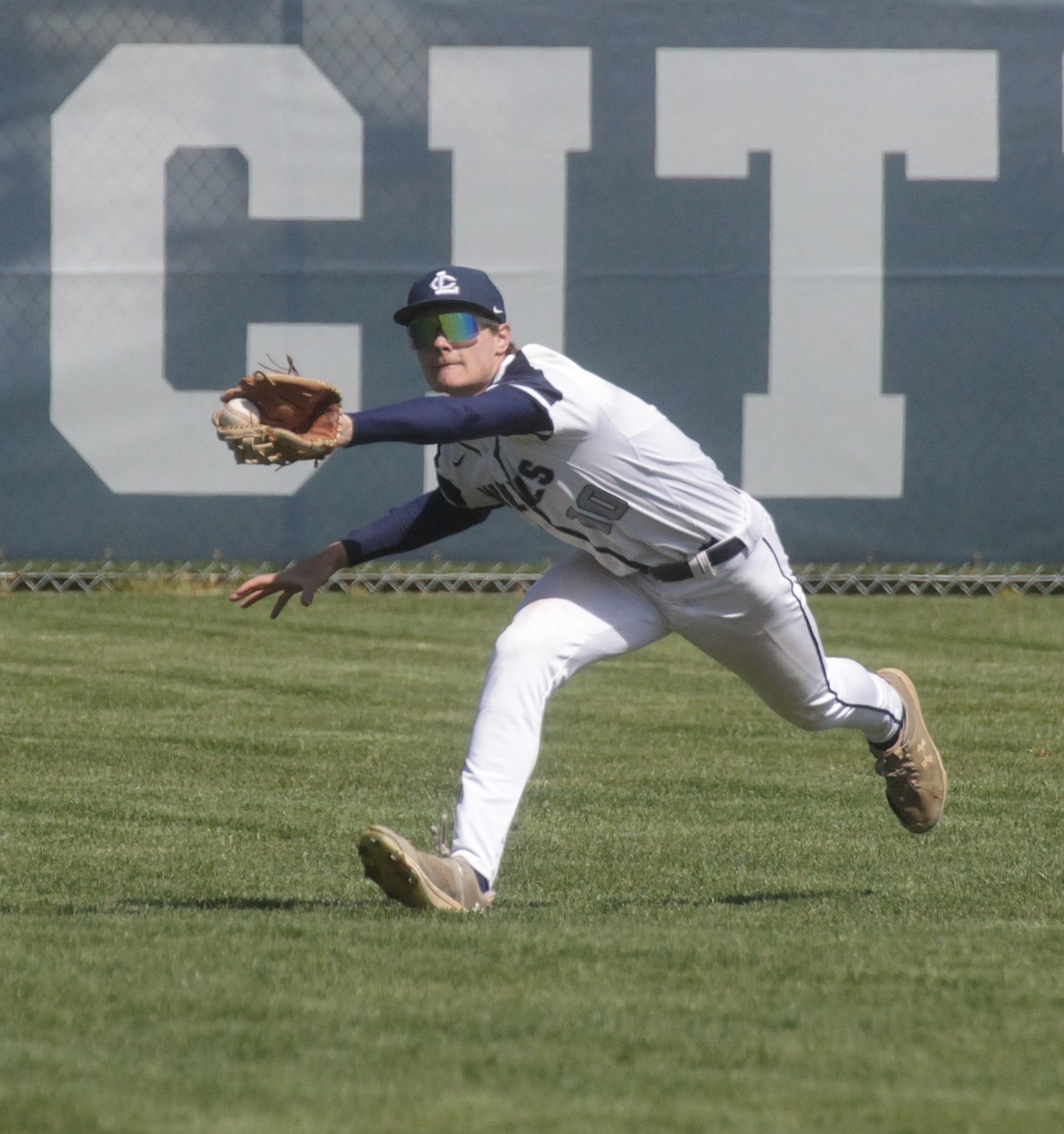 MARK NELKE/Press
Lake City senior center fielder Andy Everson nearly makes a diving catch in the first game Saturday vs. Coeur d'Alene, but the ball came loose when Everson hit the ground.