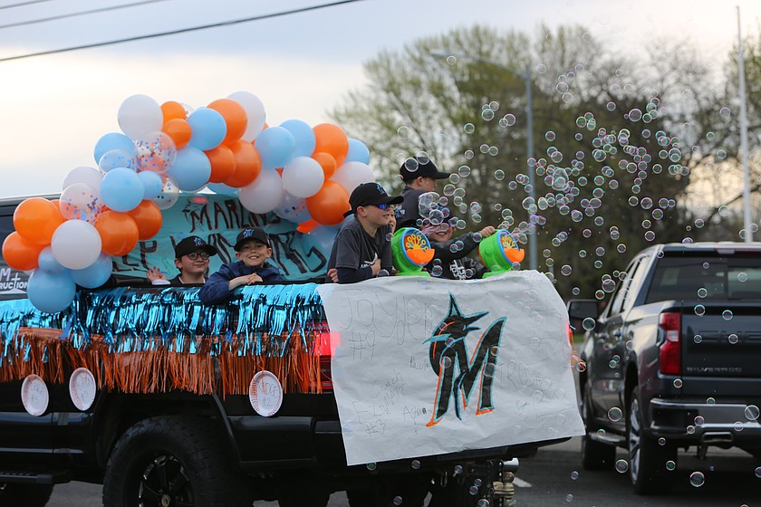The Marlins roll down the street during the Opening Day parade for youth baseball Saturday in Moses Lake.