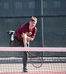 The Moses Lake Mavericks’ Kysen Chavez, in maroon, hits the ball over the net during their match against Sunnyside.