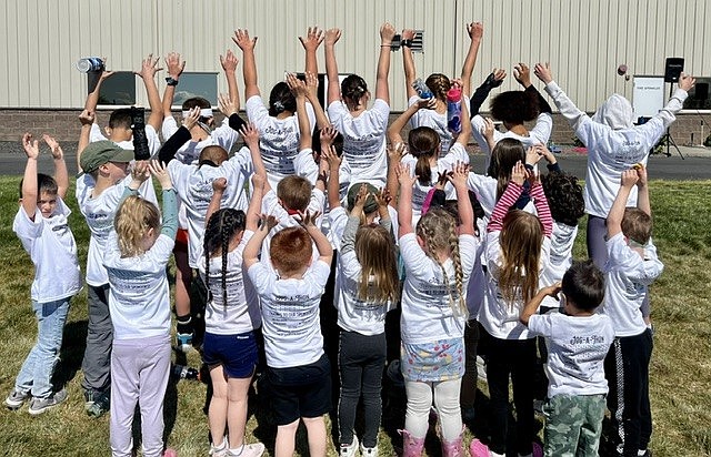 Crestview Christian School students show the T-shirts listing the names of sponsors from the annual jog-a-thon fundraiser Friday.