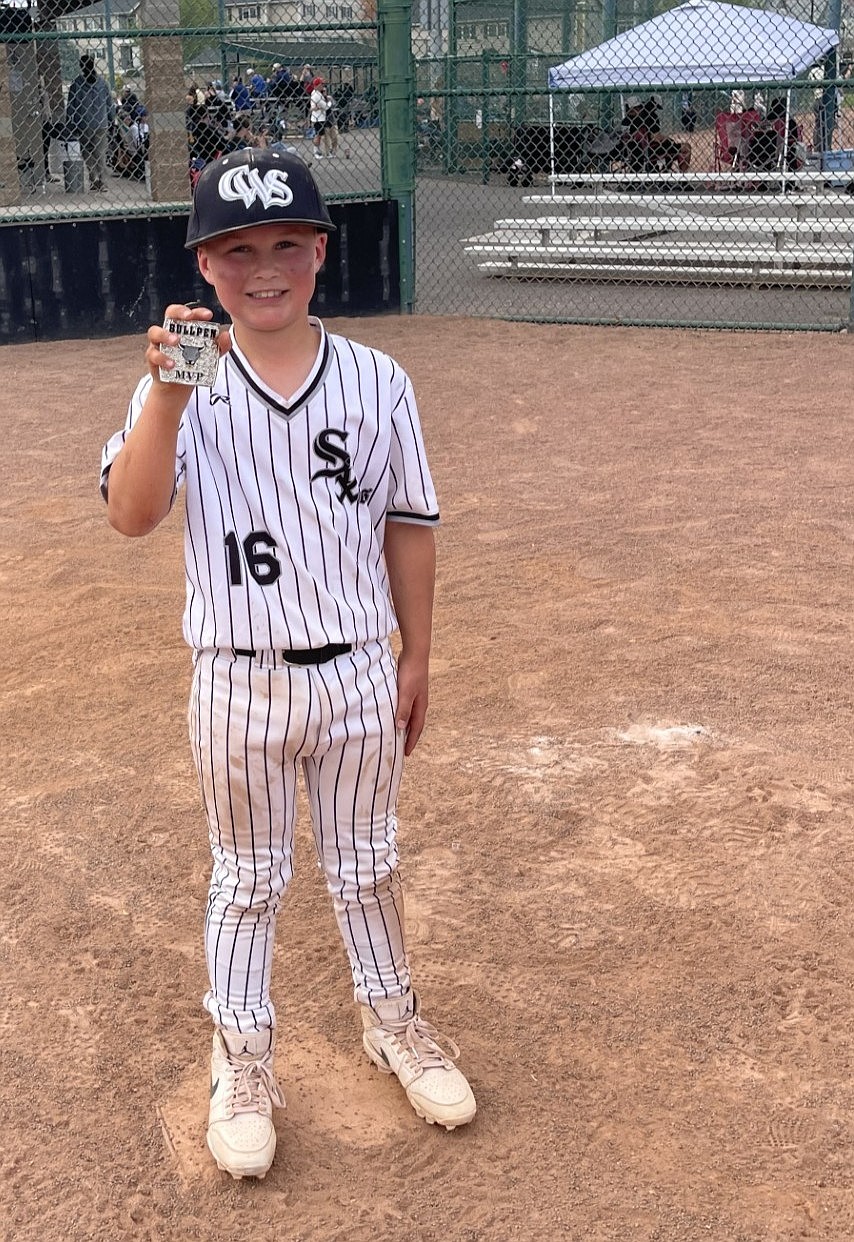 Hayes Palmer (16) holds up his Bullpen MVP award, which he earned after a strong weekend of play. Head Coach Jameson Lange said his hard work has helped him throughout the last year.