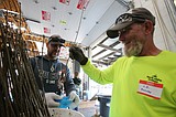 Volunteers prepare seedlings for 41st fourth grade Arbor Day giveaway