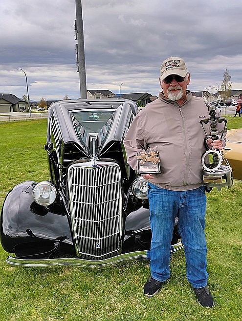 Paul Brock holds trophies while standing with his 1936 Ford Coupe at the Order of the Eastern Star's 2025 Scholarship Car Show. This year's event will be May 2 with early bird registration due by Friday.