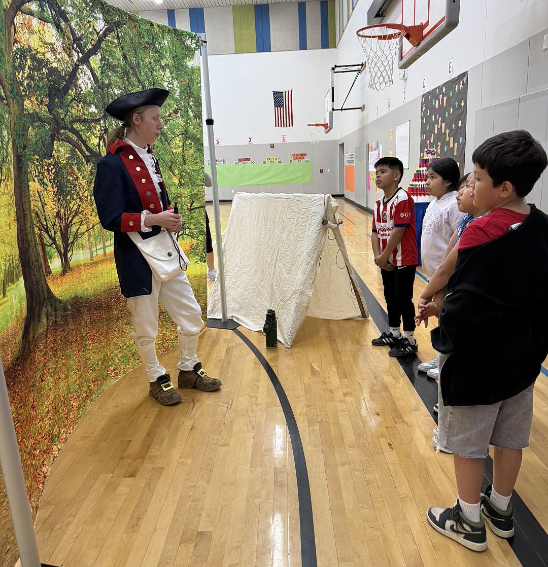 Mountain View Elementary students hear Revolutionary War stories from a Quincy Valley Historical Society volunteer playing Joseph Plumb Martin.