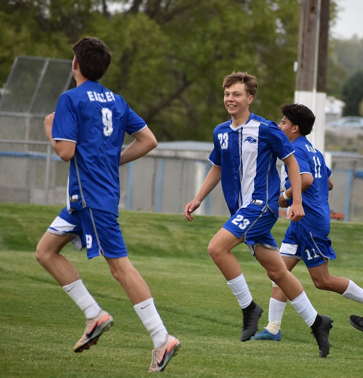 Soap Lake’s Nazar Goloborodko (23) excitedly runs alongside his teammates Savva Sochirca (9) and Damian Jimenez (11) after scoring his first goal back from vacation against Entiat Tuesday evening.
