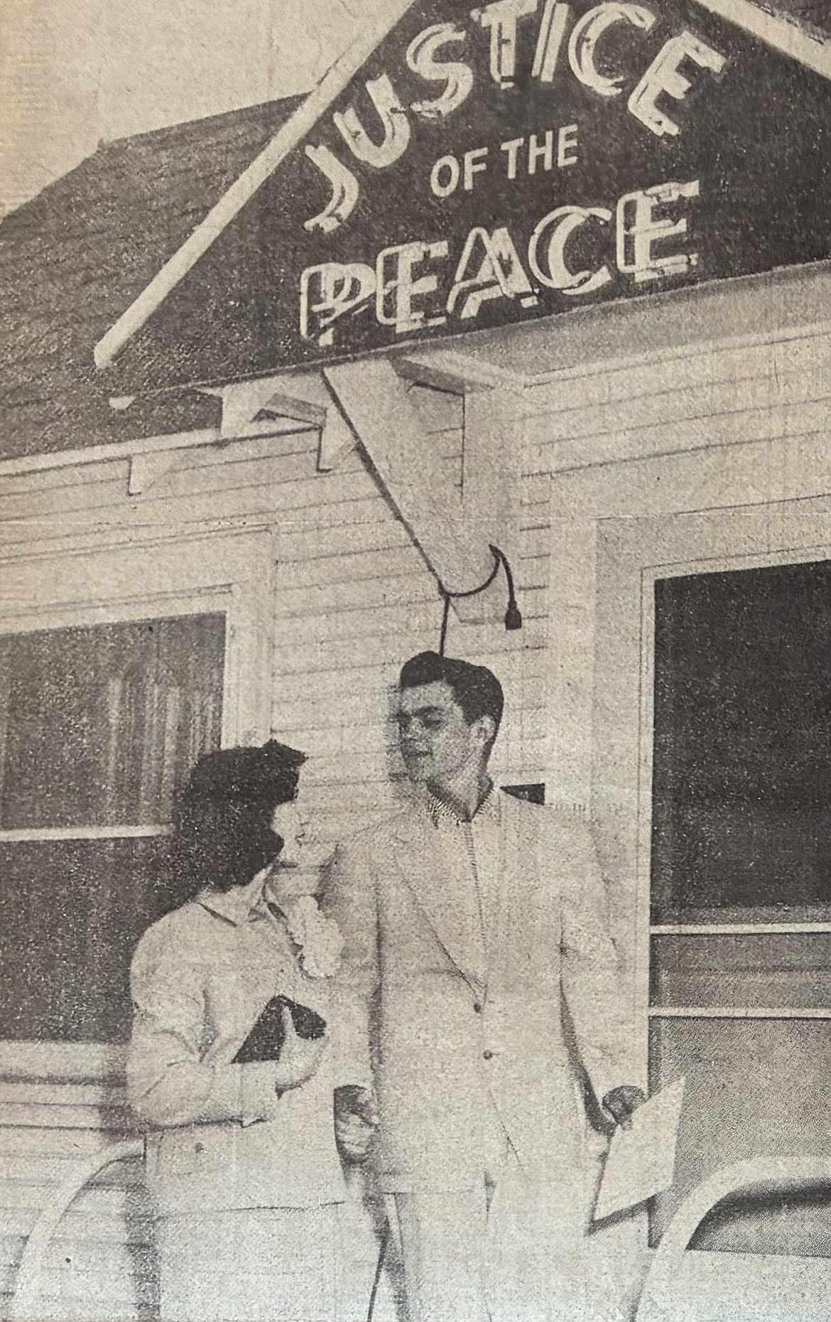 Holding a marriage license in his left hand and his fiancée, Peggy Beadles, 18, in his right one, Wayne Leroy Trenary, 19, is ready to marry on April 13, 1956.