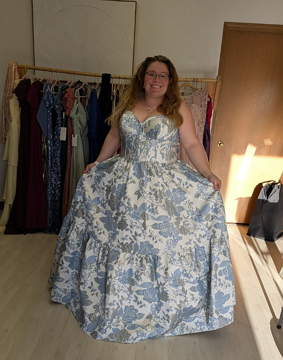Amanda Goodwin tries on a dress Monday at Barre Length + Strength during the inaugural Mom Prom Dress Swap. Mom Prom will be Saturday, May 2 at the Coeur d'Alene Eagles.