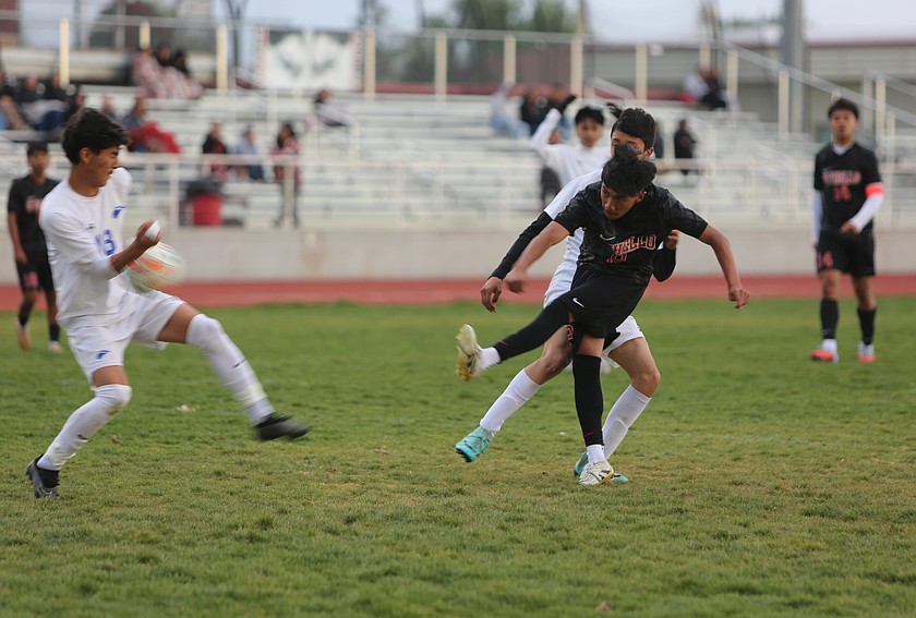 The Huskies’ Tomas Solano (9) takes a shot on goal. The Othello Huskies defeated the Warden Cougars 2-0 Thursday.