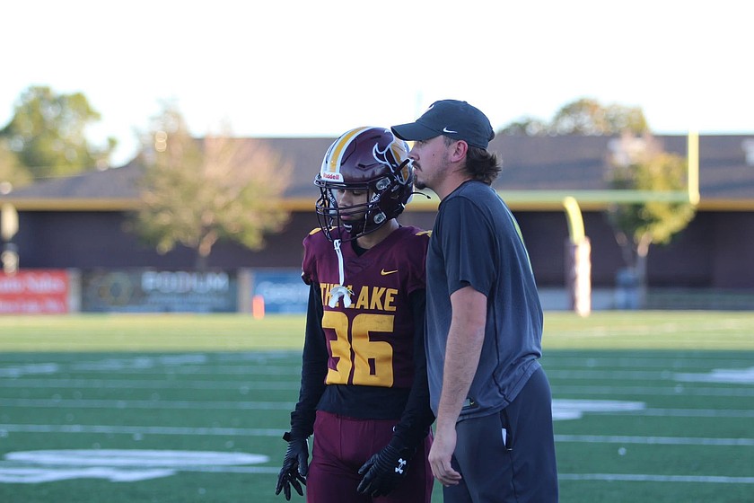 Kyler Haneberg, right, talks with a player on the sideline during a prior game in the 2024 season. Haneberg has been on the Mavericks coaching staff for seven years, and has been named the new head coach.