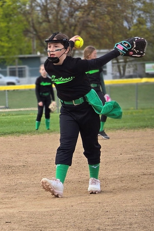Courtesy photo
Glennie Whalen of the Gemstones, an 8U softball team from the Silver Valley, pitching against the North Idaho Cardinals in Post Falls on Saturday. She struck out five against the Cardinals. She also pitched against Sandpoint last Thursday, in the rain and snow, allowing two hits and striking out six.