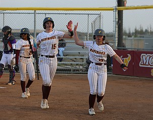 The Mavericks’ Avery Getzinger (15) and Josie Carlstrom (13) high-five after a game against Wenatchee earlier this season. The Mavericks were victorious 8-0 over Cheney on the road on Monday.