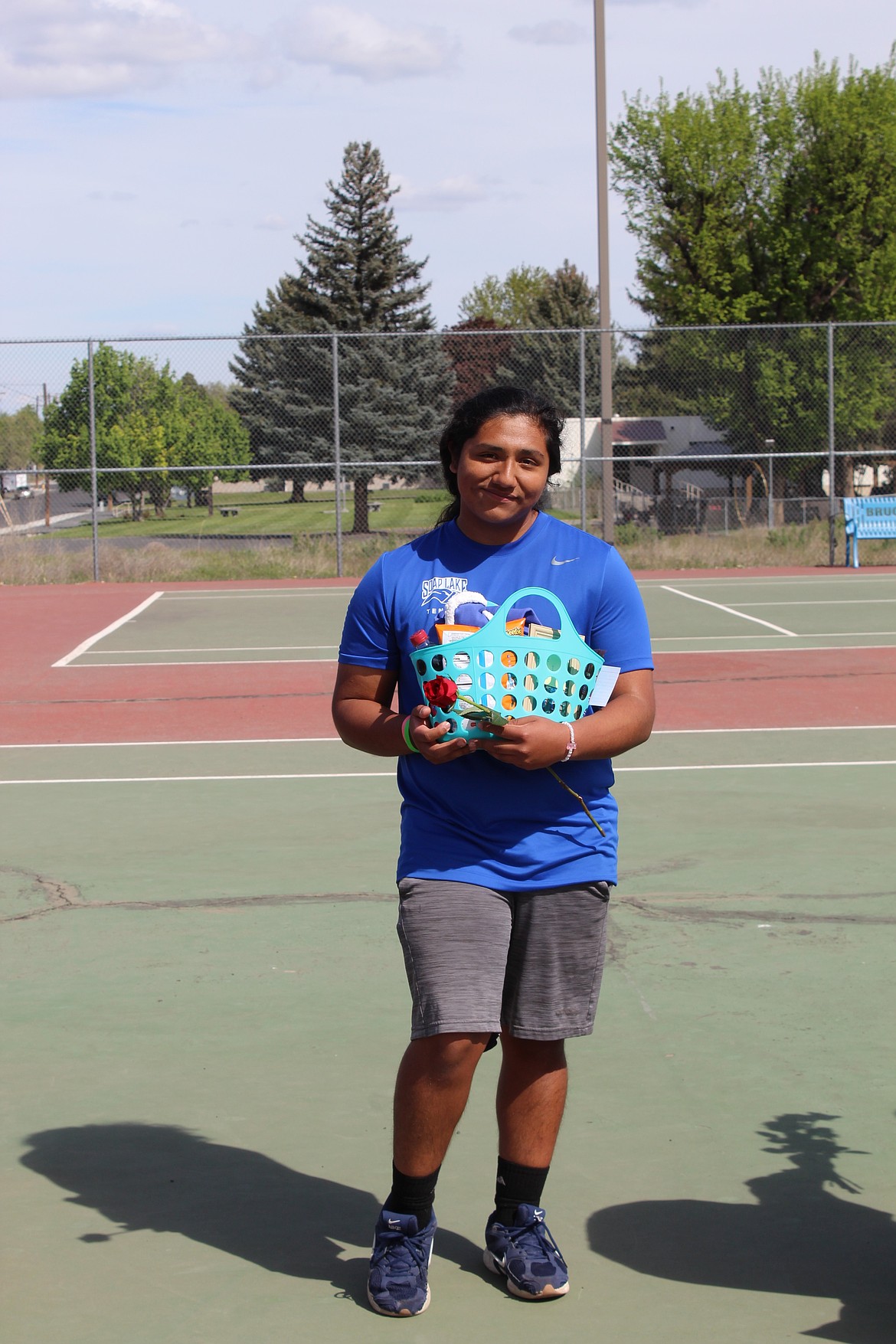 Jocsan Sanchez-Cruz from Soap Lake holds his senior basket as the team celebrates his accomplishments over his career as an Eagle.