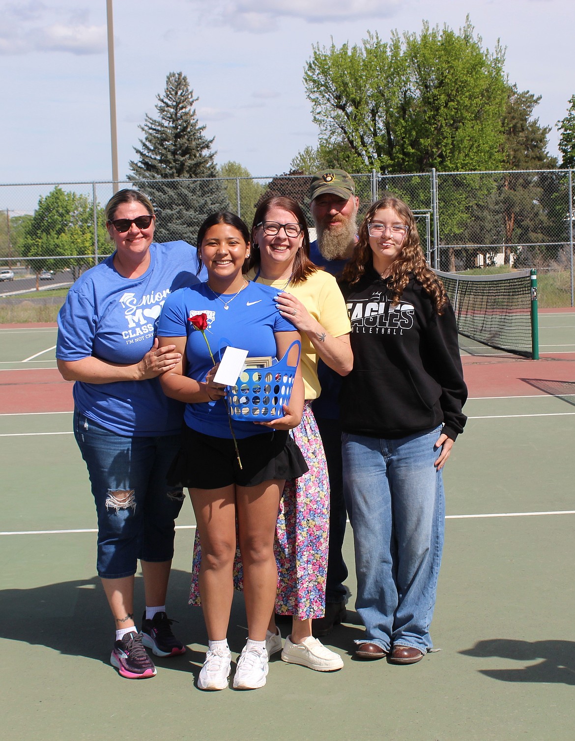 Jade Lopez from the Eagles holds her senior basket surrounded by community support during the Eagles senior night.