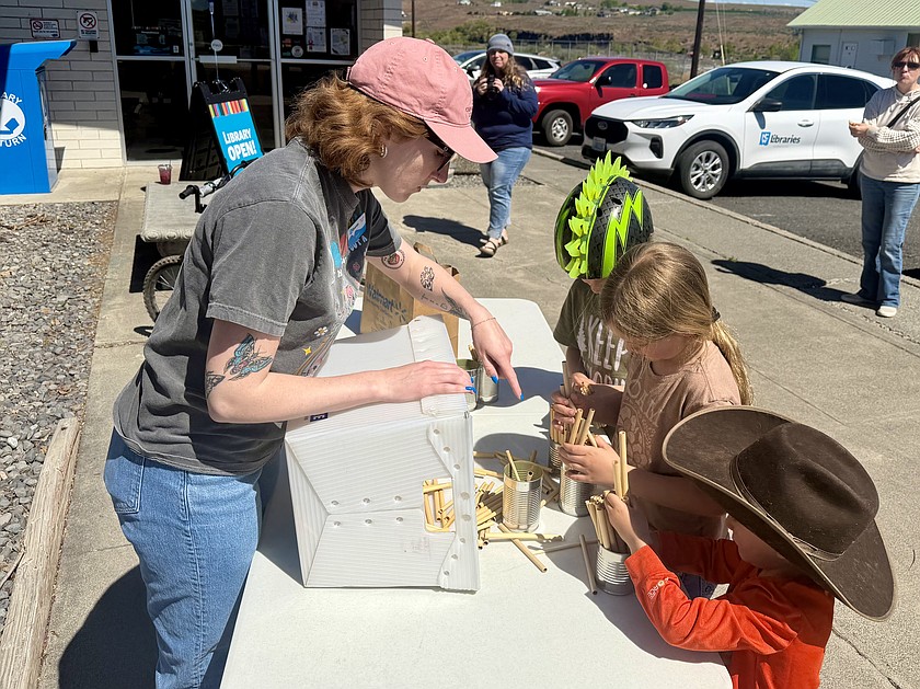 Soap Lake Librarian Evynn Olson shows off a completed bee hotel, which will serve as a home for solitary bees. Those bees will help pollinate gardens in the region.