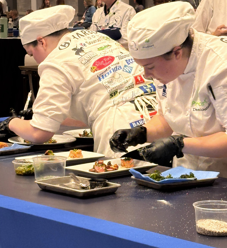 Danica Bastedo, right, and Kadence Powell feverishly work to plate Team Idaho menu items during the National ProStart Invitational, held April 24-26 in Baltimore.