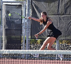 Othello senior Faith Risenmay hits the ball back over to the opposing doubles team during Thursday’s meet against Ellensburg. Risenmay and her doubles partner Shaylee Freeman claimed first place in CWAC first doubles.
