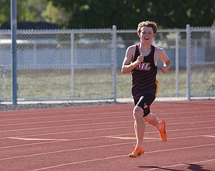 Noah Demchuk is all smiles in the Mavericks 1600-meter race Thursday. Demchuk came in third with a 4:42.43 time.