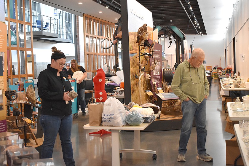 Visitors to the Moses Lake Museum & Art Center’s Rusty Mammoth sale look over treasures Saturday. The sale is the museum’s biggest fundraiser of the year.