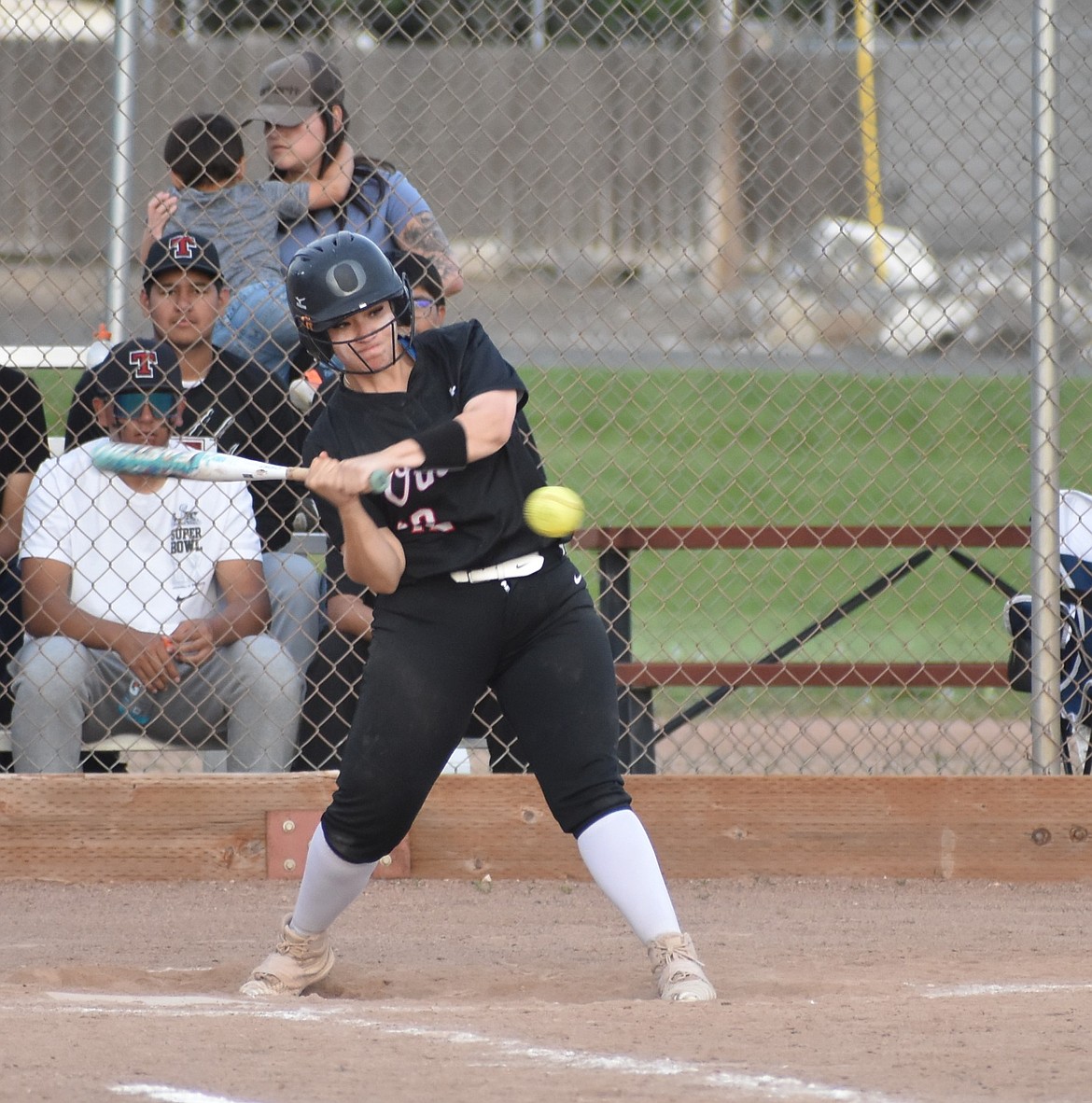 Othello’s Chita Lara takes a swing – and connects, allowing her teammate to advance to second base during Friday’s doubleheader.