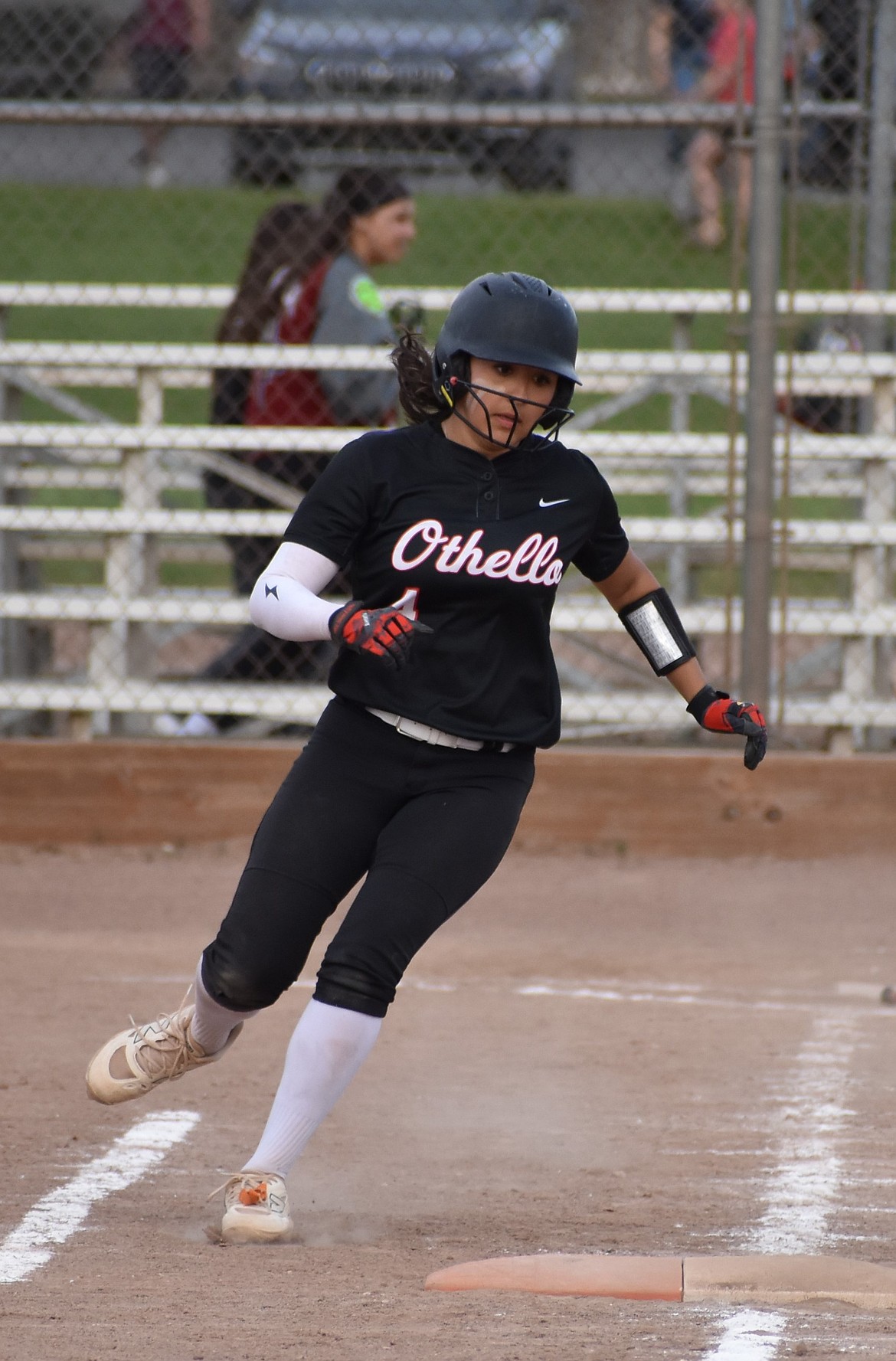 Bethany Zamora from Othello gets safe on first base after making a hit Friday evening.