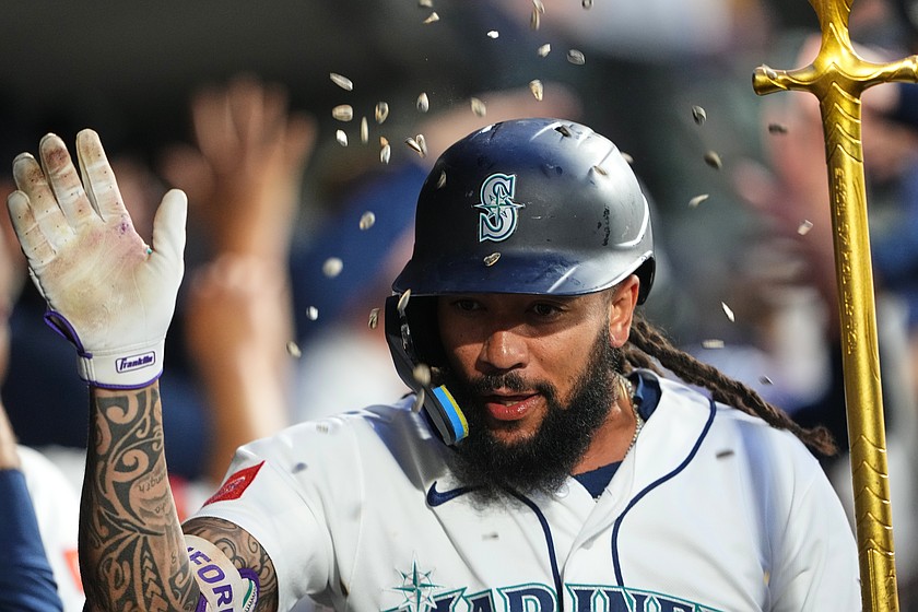 Seattle Mariners' J.P. Crawford celebrates in the dugout after hitting a two-run home run against the Atlanta Braves during the sixth inning of a baseball game, Monday, May 4, 2026, in Seattle.