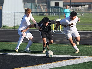 The Royal Knights’ Brian Amado (8) battles with two Oroville defenders for possession of the ball. The Knights defeated Oroville 6-0 in the first round of the 1A District 5 tournament.
