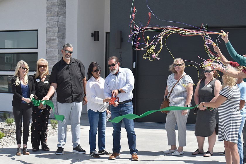 Angel and Yolanda Garza, with Jessse “Weno” Dominguez looking on, cut the ceremonial ribbon Wednesday at Sandhill Place, Palos Verdes’ development in the Mae Valley area of Moses Lake.