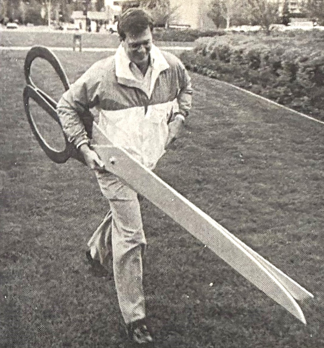 Manager Bill Reagan of The Coeur d’Alene Resort carries a giant pair of scissors to the 1991 ribbon-cutting ceremony at The Resort Plaza.
