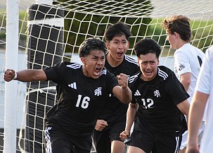 Royal junior Brayan Miron (16) celebrates his goal with his senior teammates Carlos Barajas (18) and Cristian Nieto (12) in the second half against Okanogan.