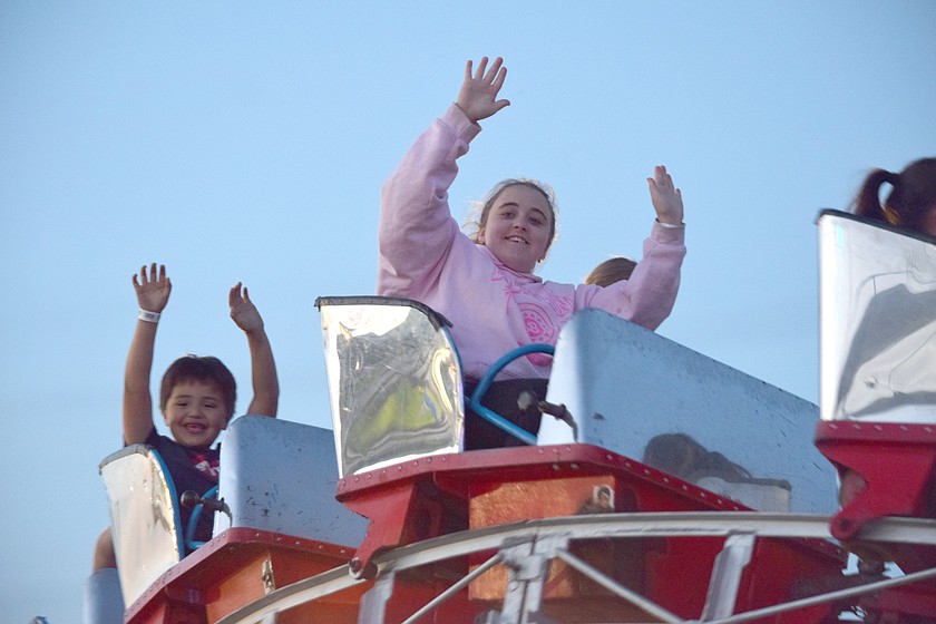 Riders reach for the sky at the Spring Fest carnival last year. The festival, which takes place Memorial Day weekend, draws tens of thousands of revelers every year.