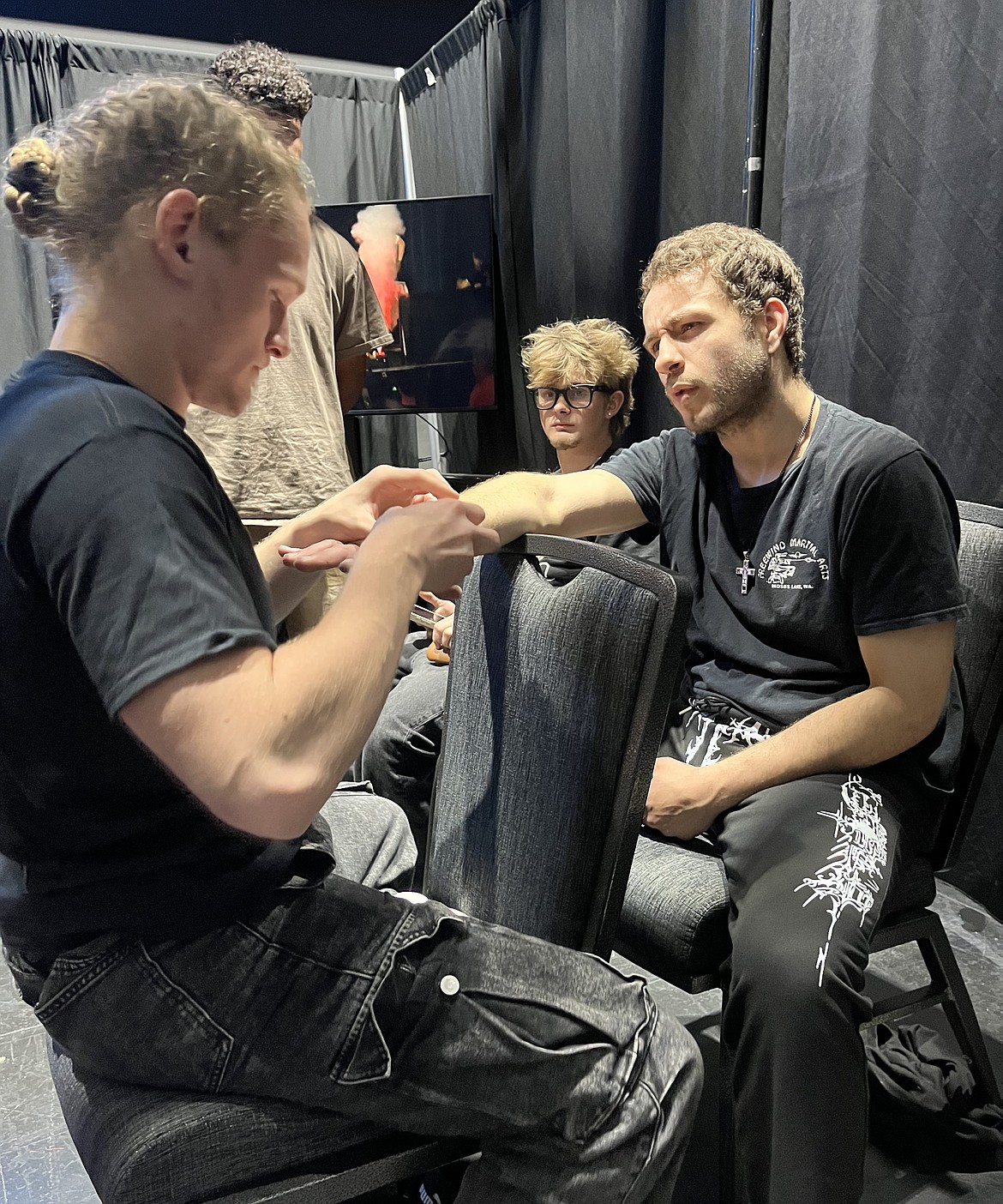 Jacob Guertin, left, helps another MMA fighter tape their hands before a fight at Conquest of the Cage in Spokane.