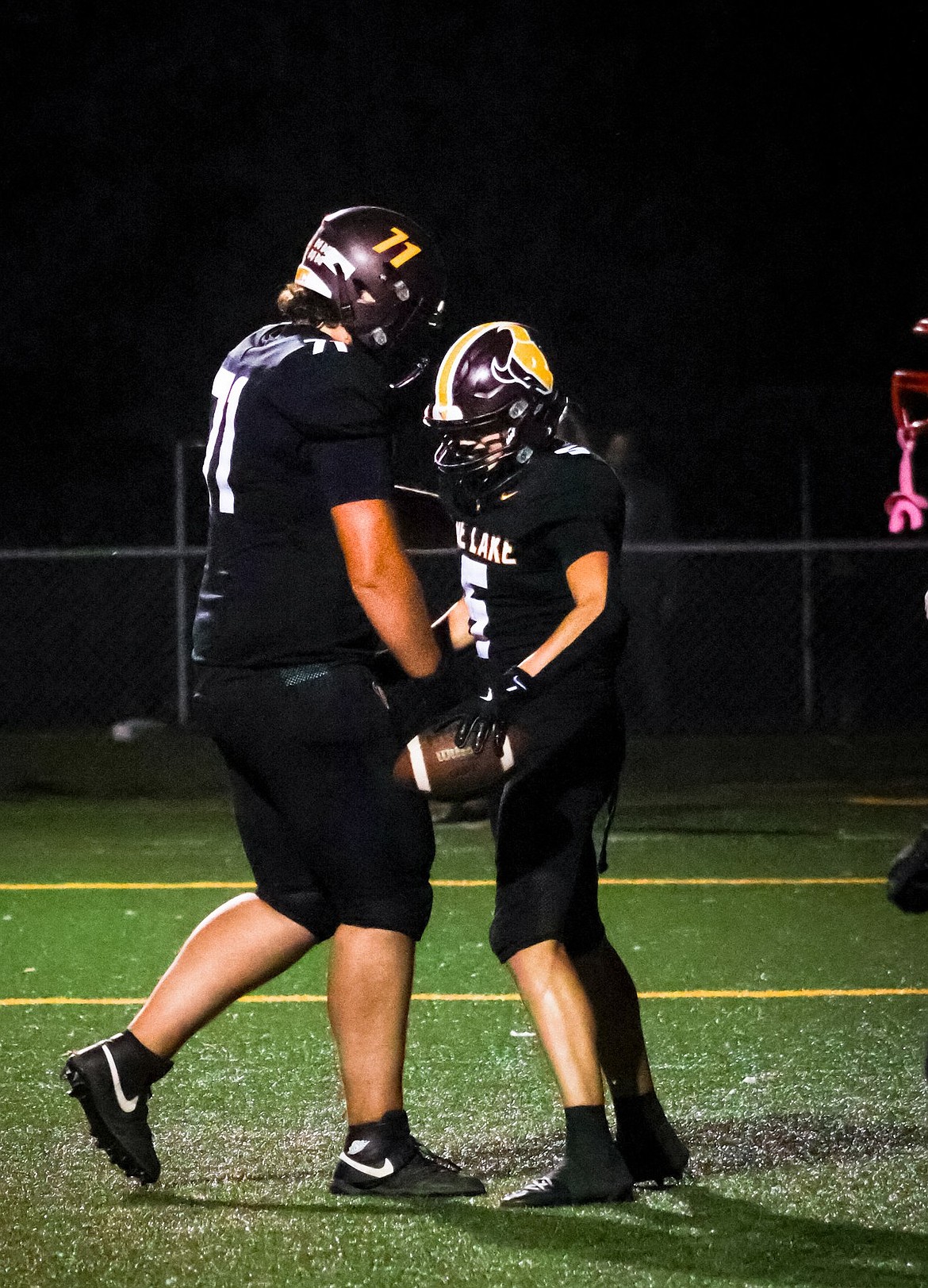 Jeremiah Baker (71) celebrates in the endzone with Case Anderson (5) during a home game last season.