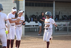 Mya Martinez (22) is all smiles being greeted by her team after hitting a home run against Sunnyside Tuesday. Moses Lake defeated the Grizzlies 16-0.