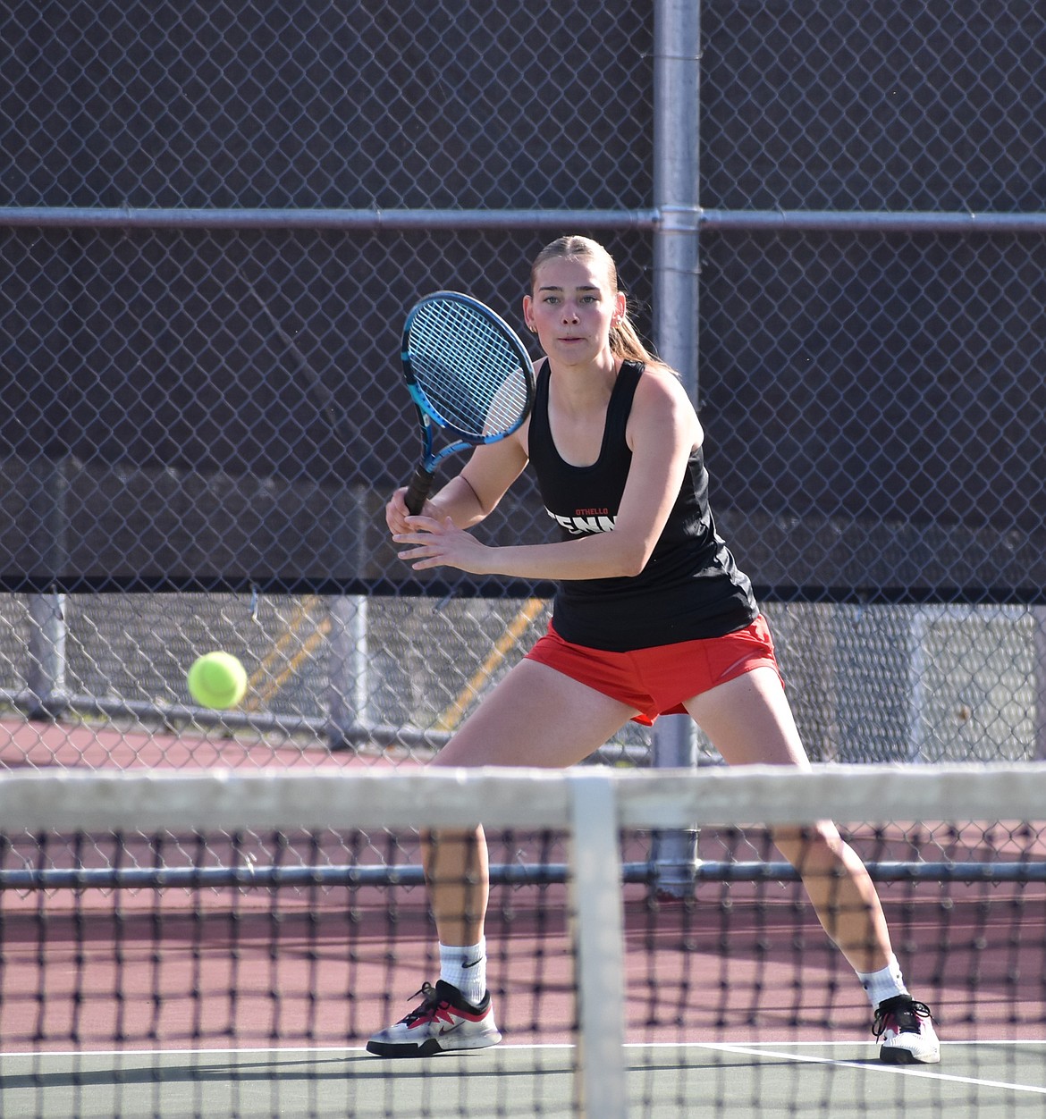 Huskies player Alexa Peterson watches the ball as she gets ready to hit it back to her opponents.