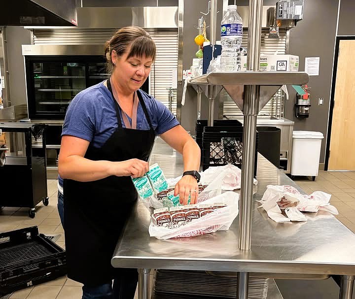 A food service employee packaged summer meals last year for students. The district served 25,000 meals throughout the summer, an increase of nearly 6,000 from the year prior.