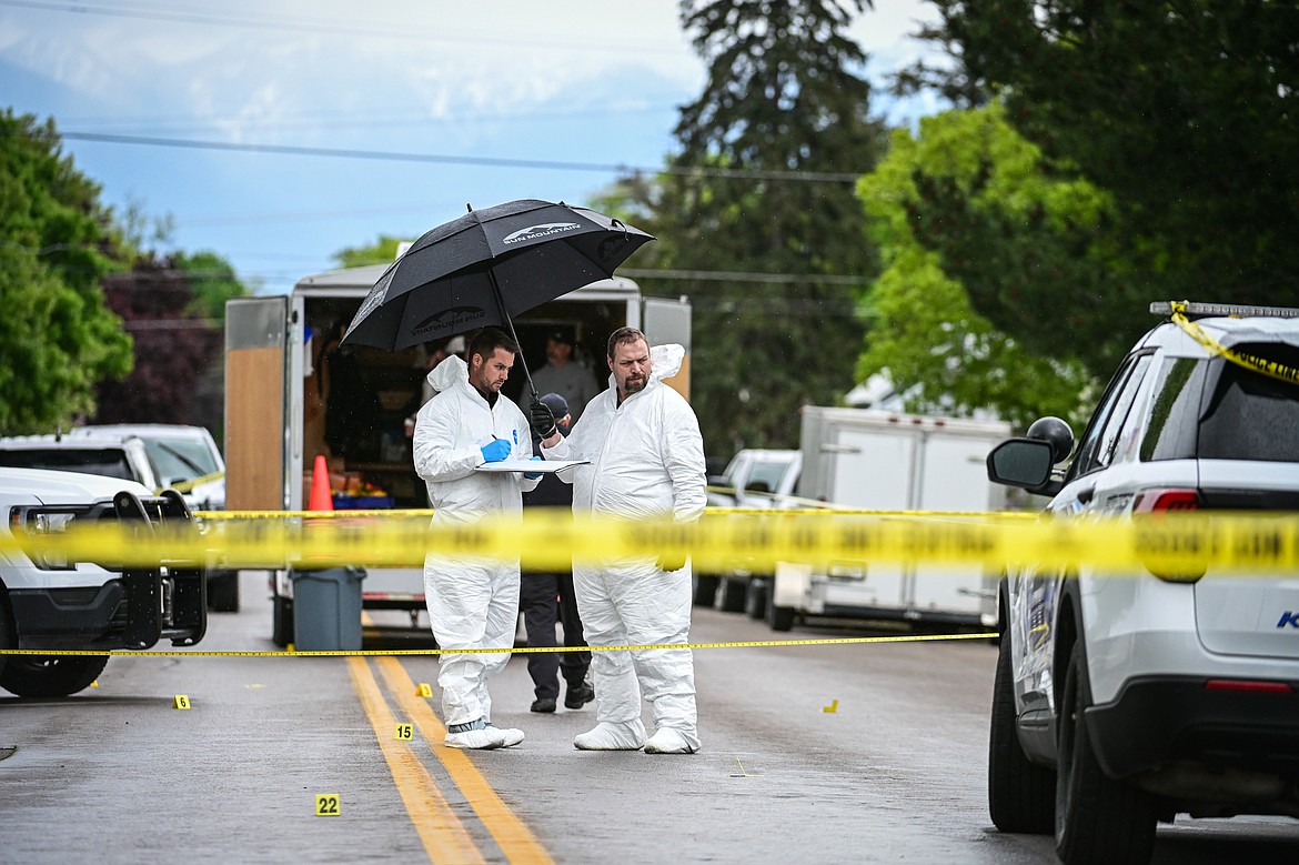 Evidence technicians and other law enforcement personnel work at the scene of a death investigation along Second Street West at 10th Avenue West in Kalispell on Saturday, May 16. (Casey Kreider/Daily Inter Lake)