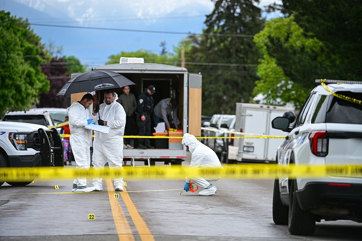 Evidence technicians and other law enforcement personnel work at the scene of a death investigation along Second Street West at 10th Avenue West in Kalispell on Saturday, May 16. (Casey Kreider/Daily Inter Lake)