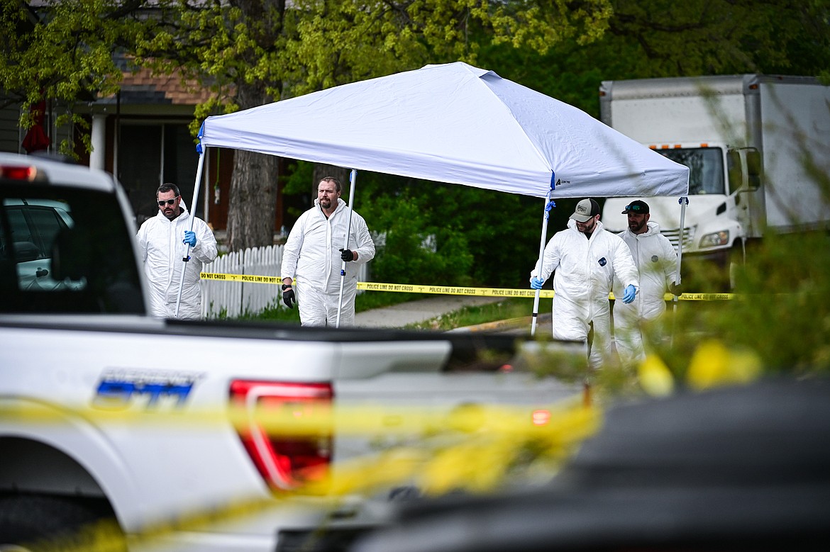 Evidence technicians and other law enforcement personnel work at the scene of a death investigation along Second Street West at 10th Avenue West in Kalispell on Saturday, May 16. (Casey Kreider/Daily Inter Lake)