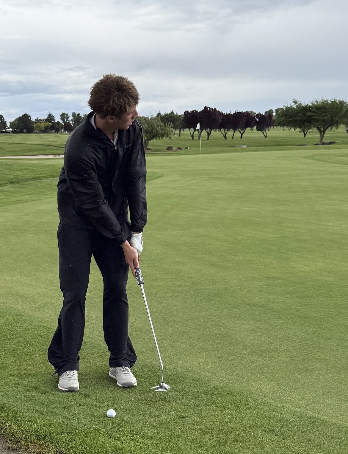 Cougars sophomore JJ Madsen looks toward the hole as he plans out his swing during the district golf tournament Wednesday.