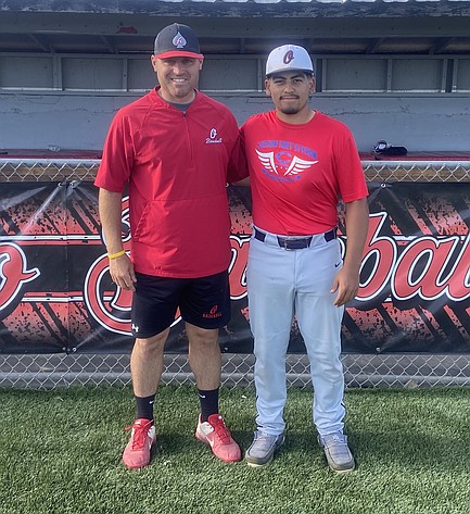The Othello Huskies Head Coach Sonny Garza, left, and Xzyyvn Martinez stand together for a photo. Garza earned Central Washington Athletic Conference coach of the year honors while Martinez was named the most valuable player.