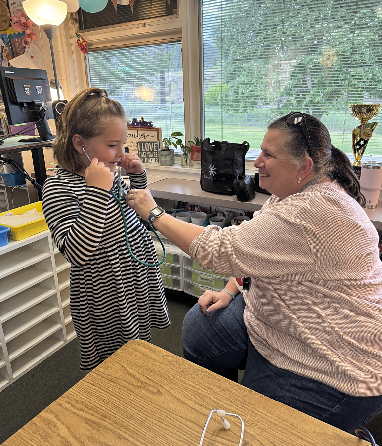 Olivia Phay listens to her heartbeat with teacher Jennifer Durocher at the Life Flight nurse station May 14 during Fernan STEM Academy's "Exploring Our World" STEM night. Nearly 440 people visited the school during the evening.