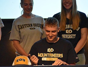 Johnny Ferguson signs his letter of intent to continue his basketball career with Eastern Oregon University.