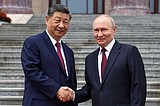 Putin and Xi hail their friendship and growing energy trade at their meeting in Beijing