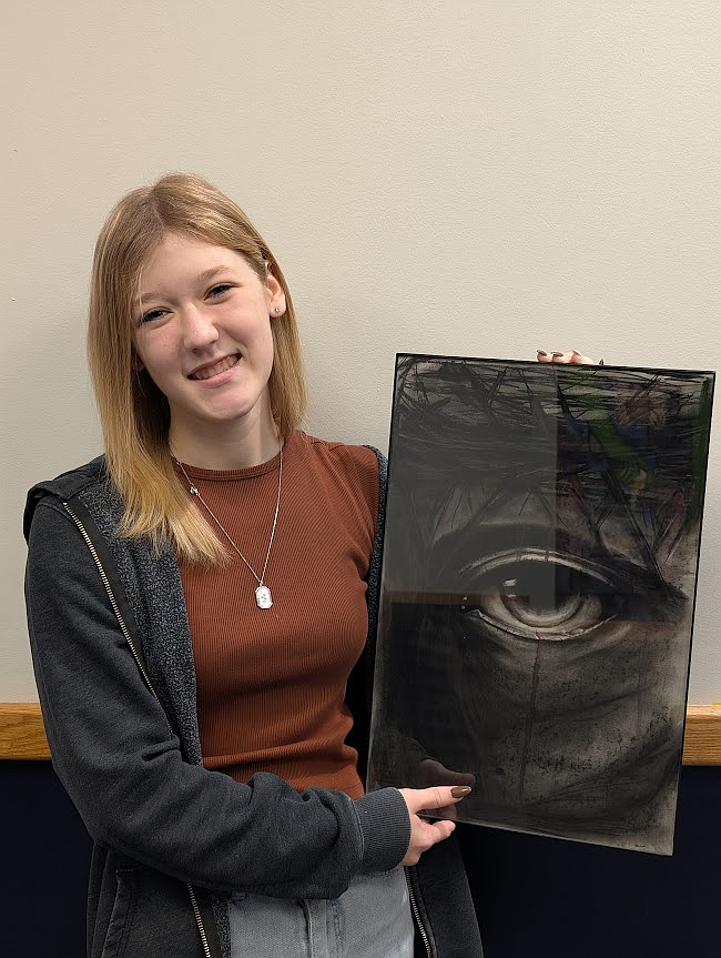 Timberlake High senior Shelby Adkison pursued an installation artwork this year that was displayed and experienced at Timberlake's annual Night of the Arts. Her installation was a recreation of "The Last Supper," inspired by the Bible. It consists of 13 charcoal portraits of Jesus's 12 disciples, and in the middle Jesus is represented with a close-up composition of the eye of Jesus and his crown of thorns (pictured).