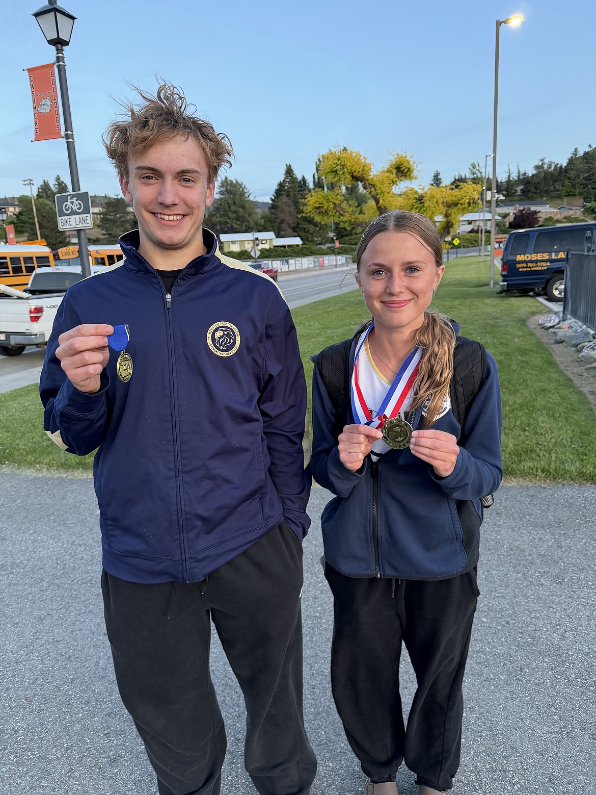 Ben Bishop and Amelia Shopbell from the Lions stand together with their first-place medals after competing in the district tournament.